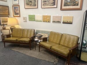 A matched pair of vintage Mid-Century Modern wood-framed loveseats